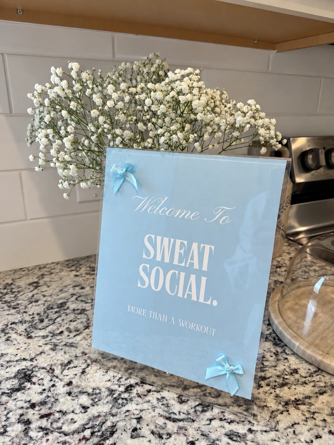 Sweat Social welcome sign with flowers